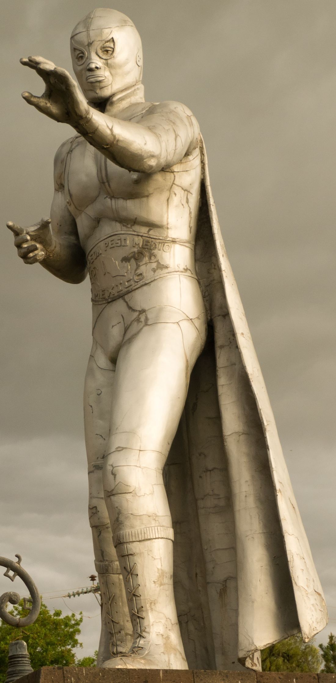 A statue of El Santo in his silver mask and wrestling gear