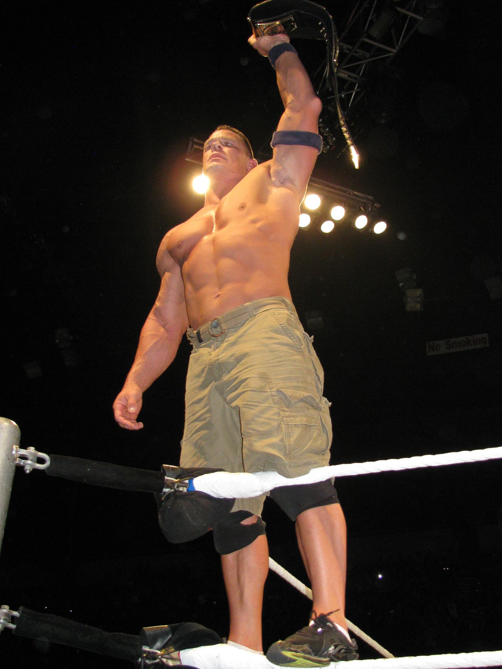 John Cena holding up the WWE Championship belt at a live event in Adelaide, Australia