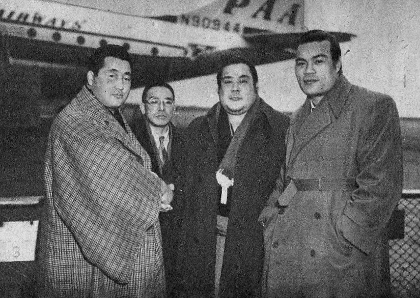Rikidozan standing with a group of sumo wrestlers in 1952